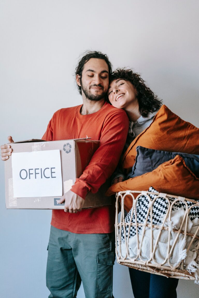 Expat parents packing moving boxes together during an international relocation.