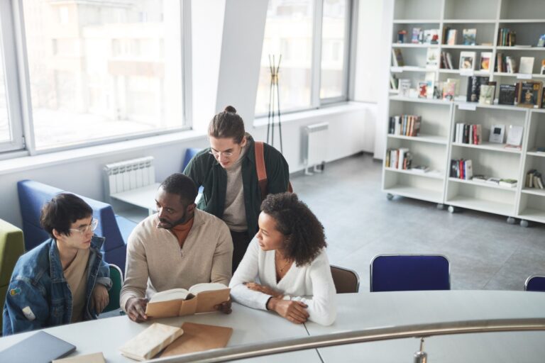Four students studying together in a classroom setting in Amsterdam.