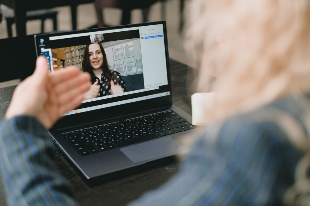 Expat parents having a focused 50-minute strategic video call consultation with an education advisor on a laptop.